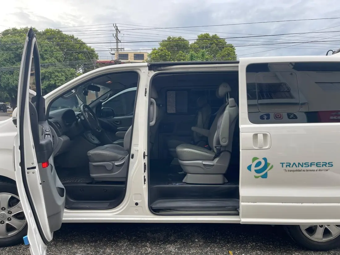 White eTransferSDQ minivan with its doors open and the leather seats in view