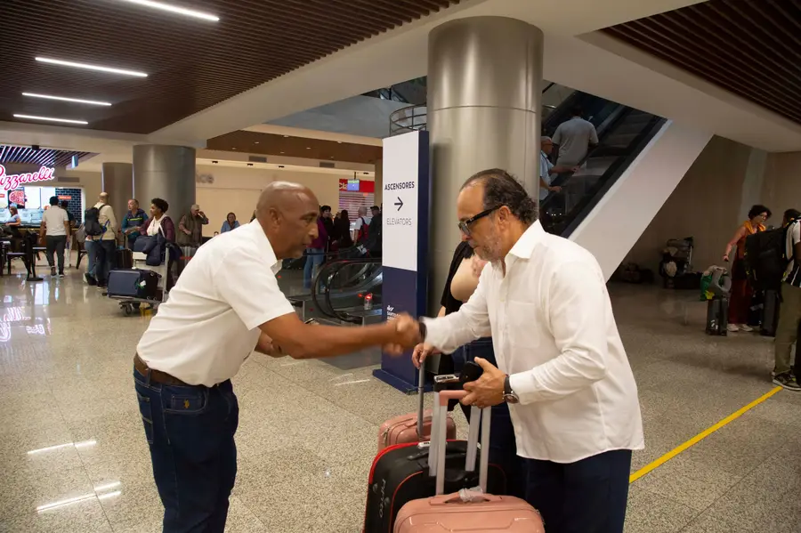 eTransferSDQ greeter shakes hands with clients to see them off inside the terminal