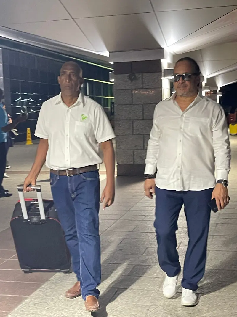 eTransferSDQ staff walk a passenger with a suitcase out of the airport