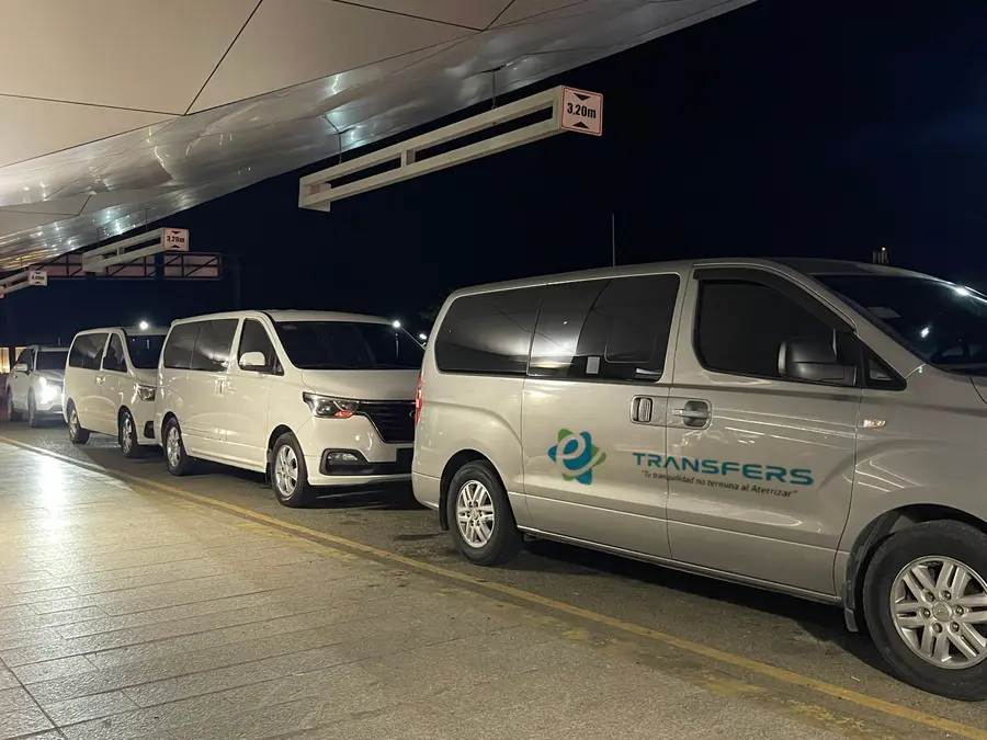 Minivans waiting outside the terminal at night