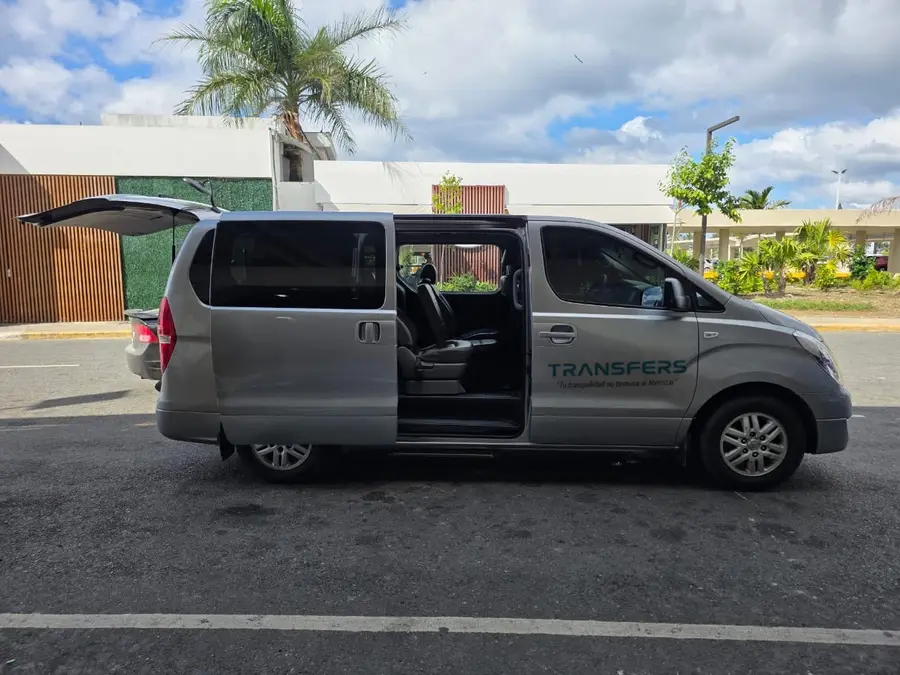 Silver minivan with the side door and boot open
